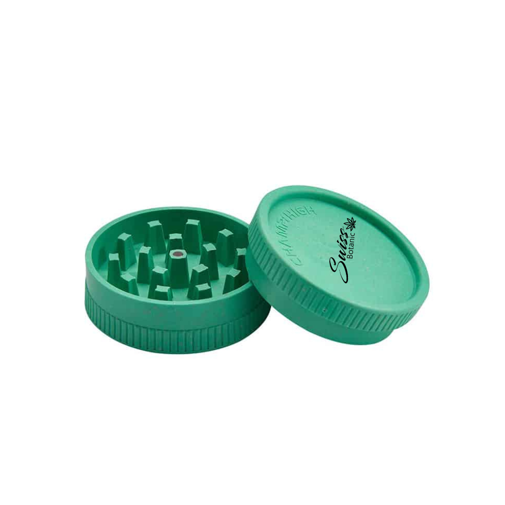 Two halves of the green plastic Grinder Swiss Botanic, with one flipped upside down to show raised grinding teeth.