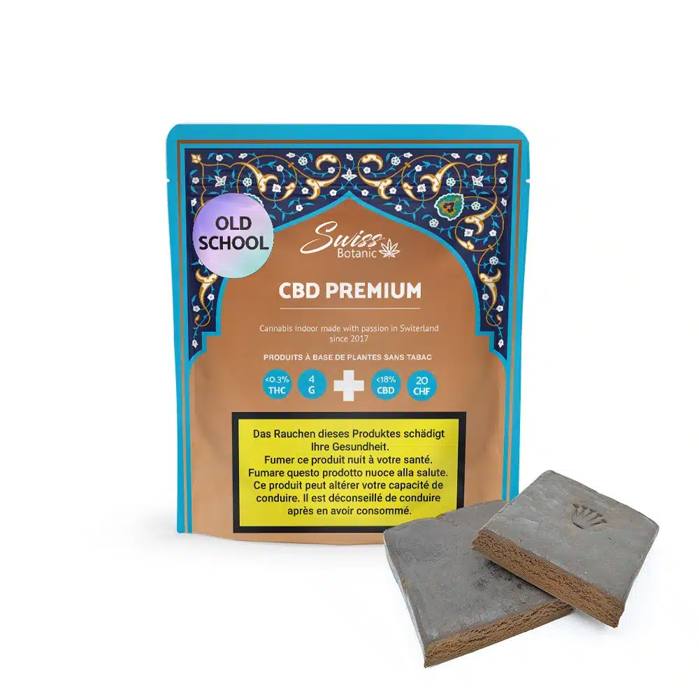 A packet labeled "Old School Hash CBD Premium" with Swiss Botanic branding and two brown compressed blocks displayed in front of the package.