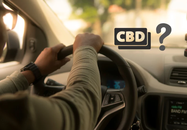 A man driving a car with a cbd sign on the dashboard.