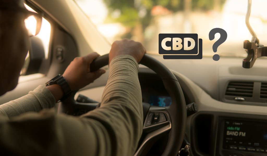 A man driving a car with a cbd sign on the dashboard.