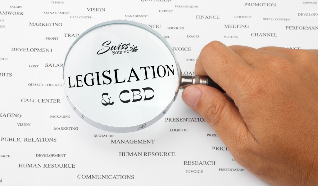 Une personne tenant une loupe sur le mot législation et cbd.