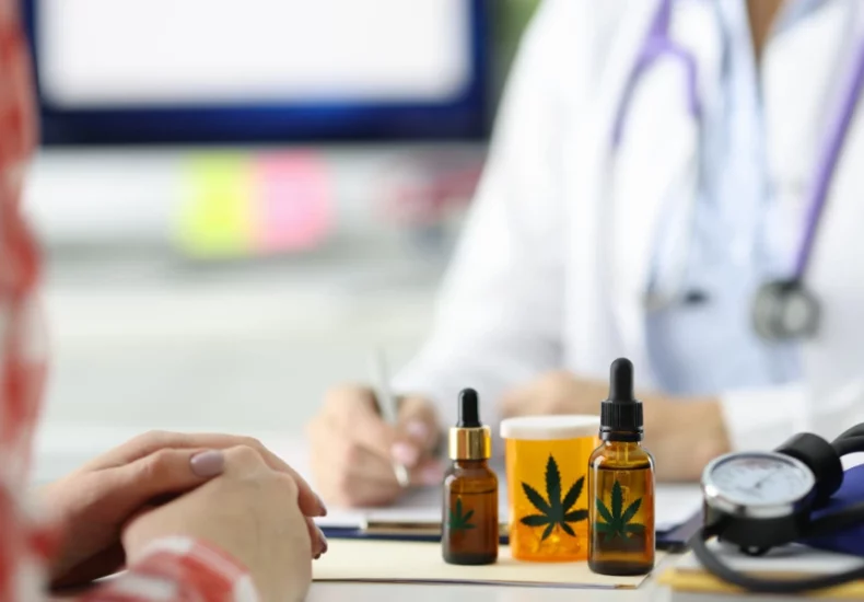 Understanding cannabinoid withdrawal 5 A woman is sitting at a desk with a stethoscope and cbd oil.