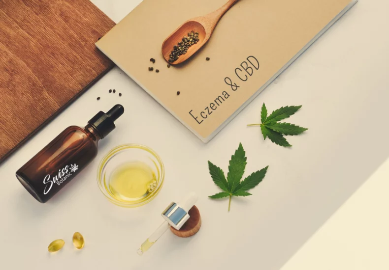 Cbd and eczema: a natural solution to soothe the skin 6 On the table is a bottle of cbd oil next to a book.