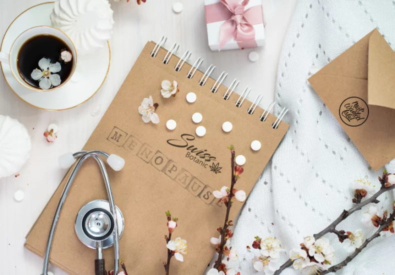 Cbd and menopause: a natural approach to alleviate symptoms 9 A notebook with a stethoscope and a cup of coffee.